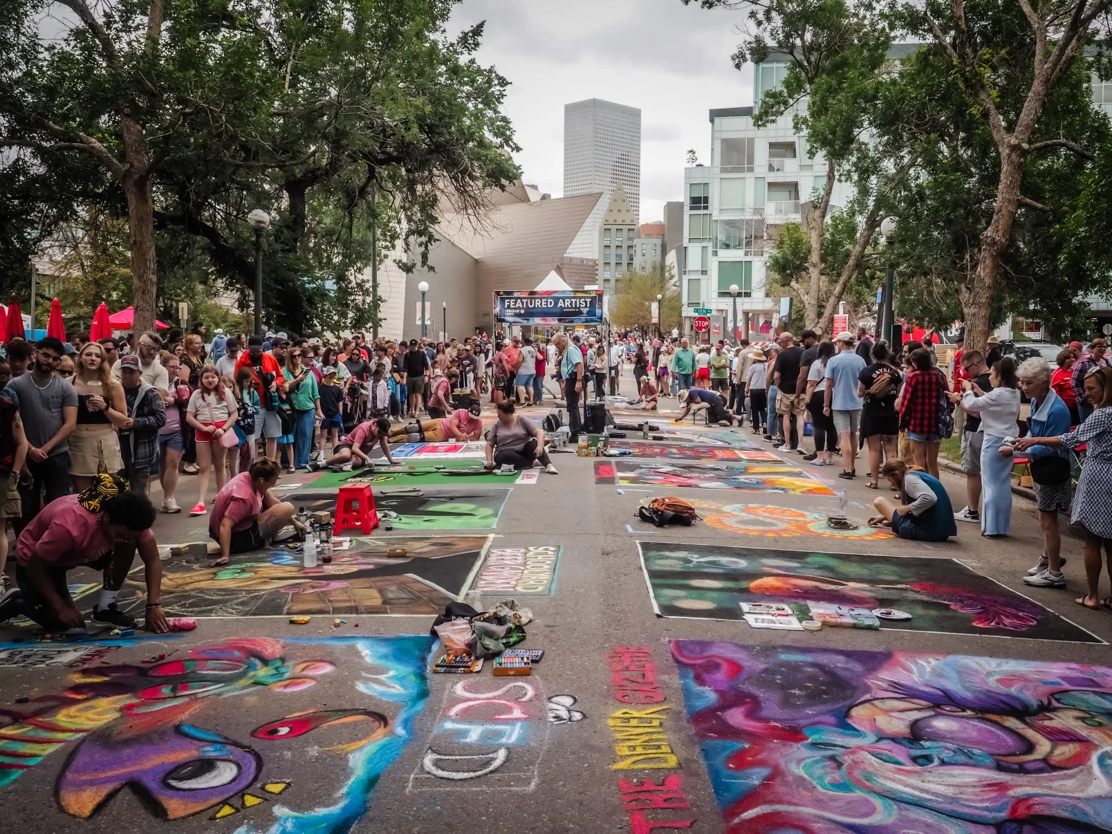 Watch pavement transform with color at Denver Chalk Art...